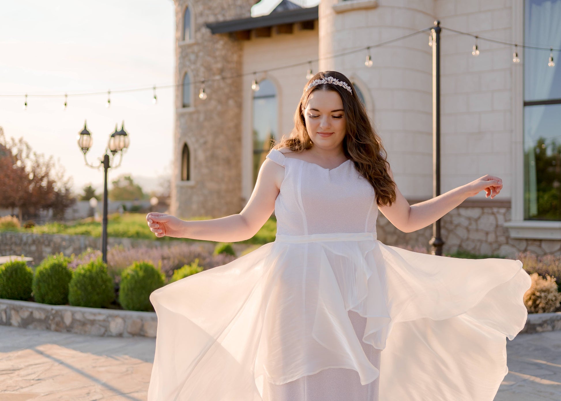 Bride tossing the Amber skirt in the air and letting it floating down, showcasing movement and transparency of the organza overlay