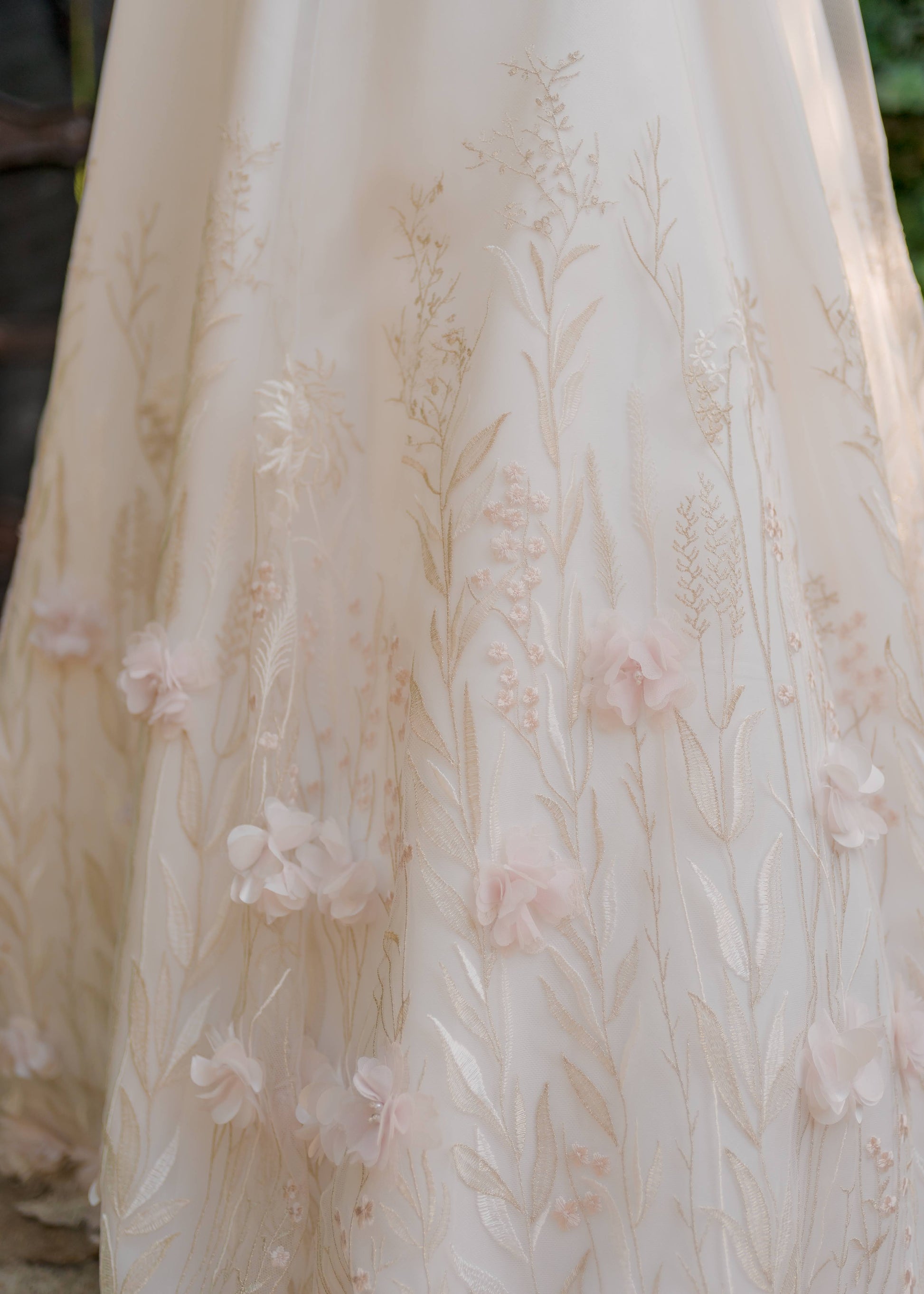 Close up of the lace on the prue skirt with the ivory, pink, and silver wildflower-inspired lace and 3d chiffon pink flower petals.