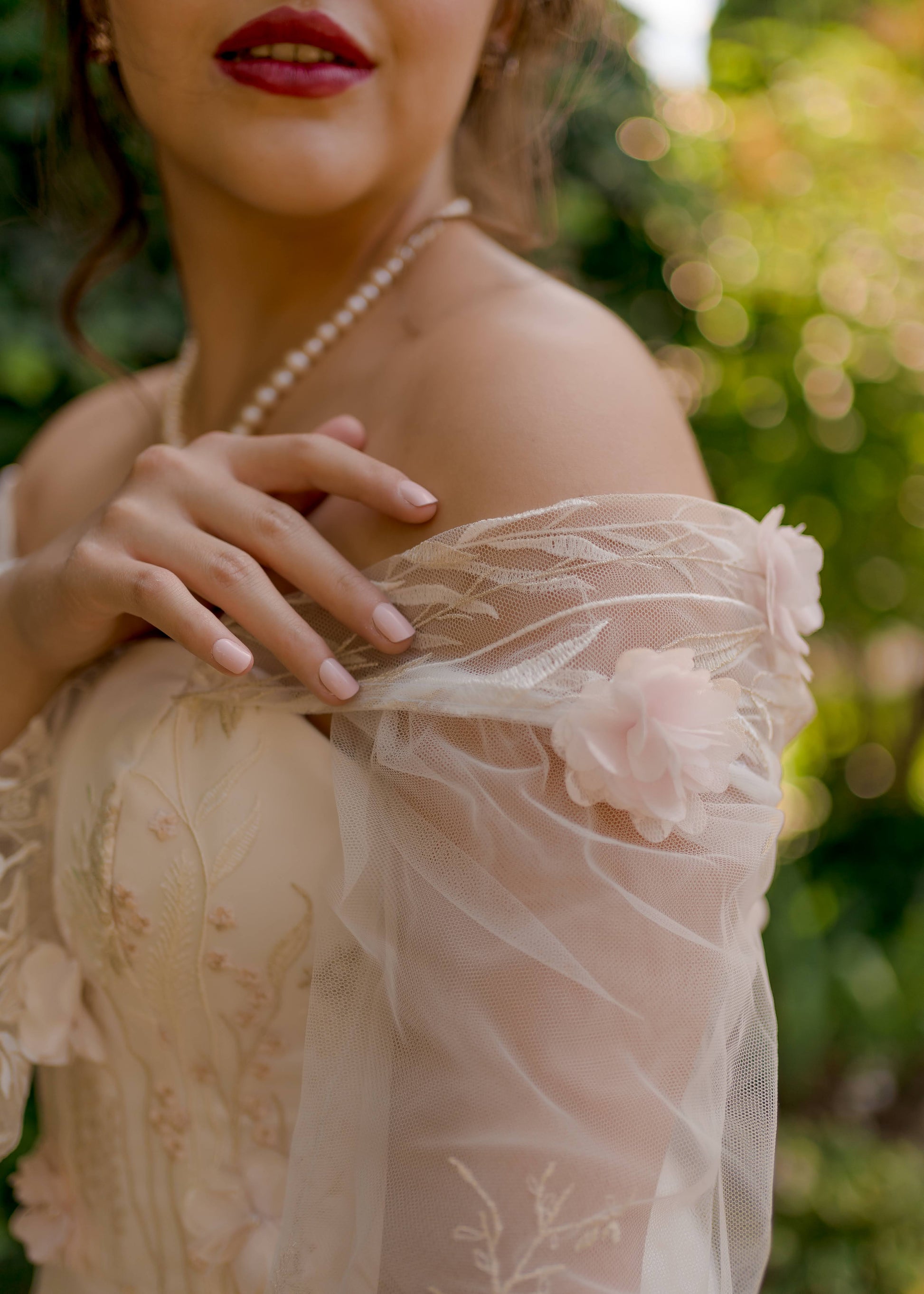 Close up detail of the off the pleated off-the-shoulder strap with gathered bishop sleeve on the Prue bridal gown.