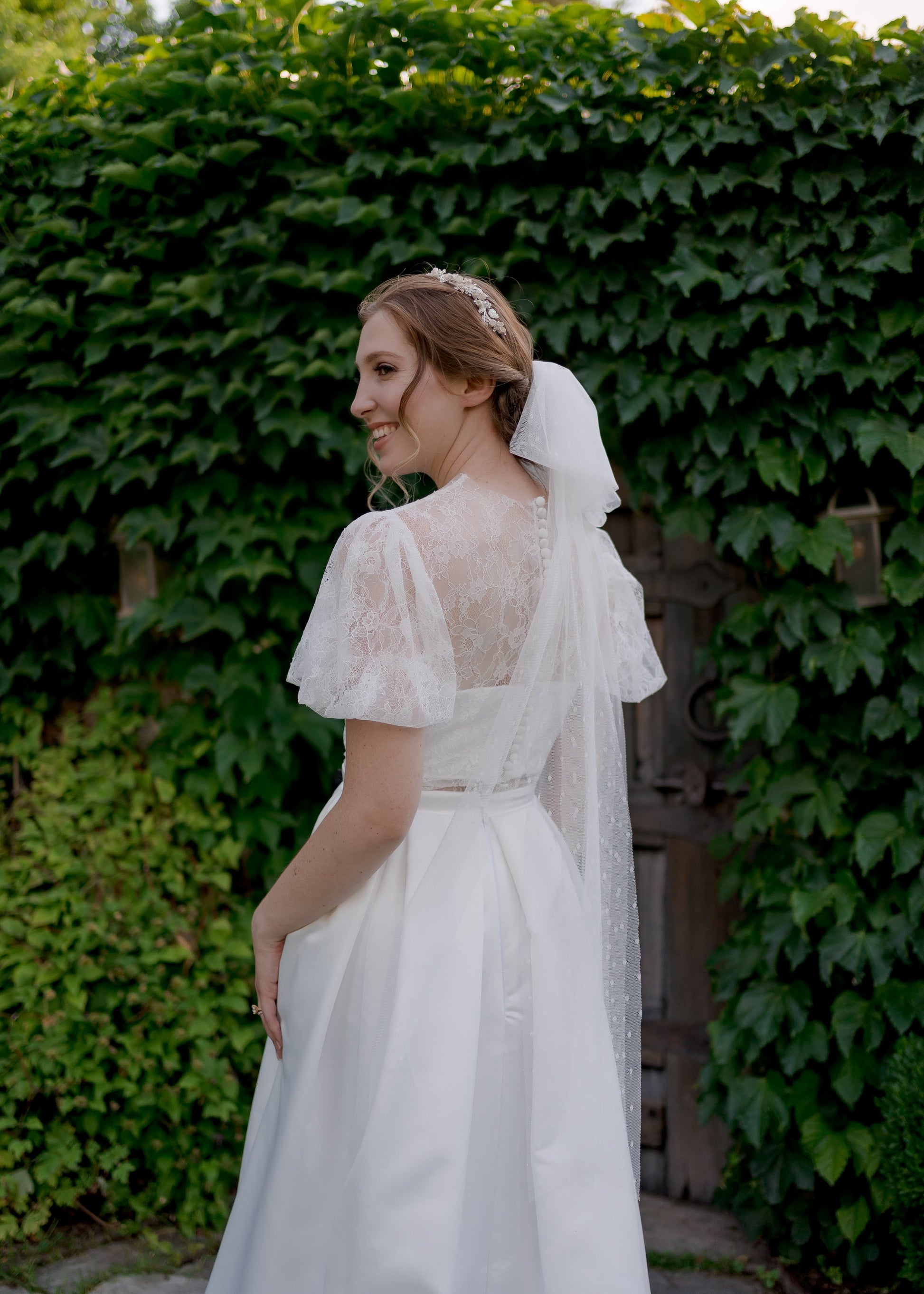 Back view of jessa; she is paired with Swiss Dot Tess bow veil in fingertip length