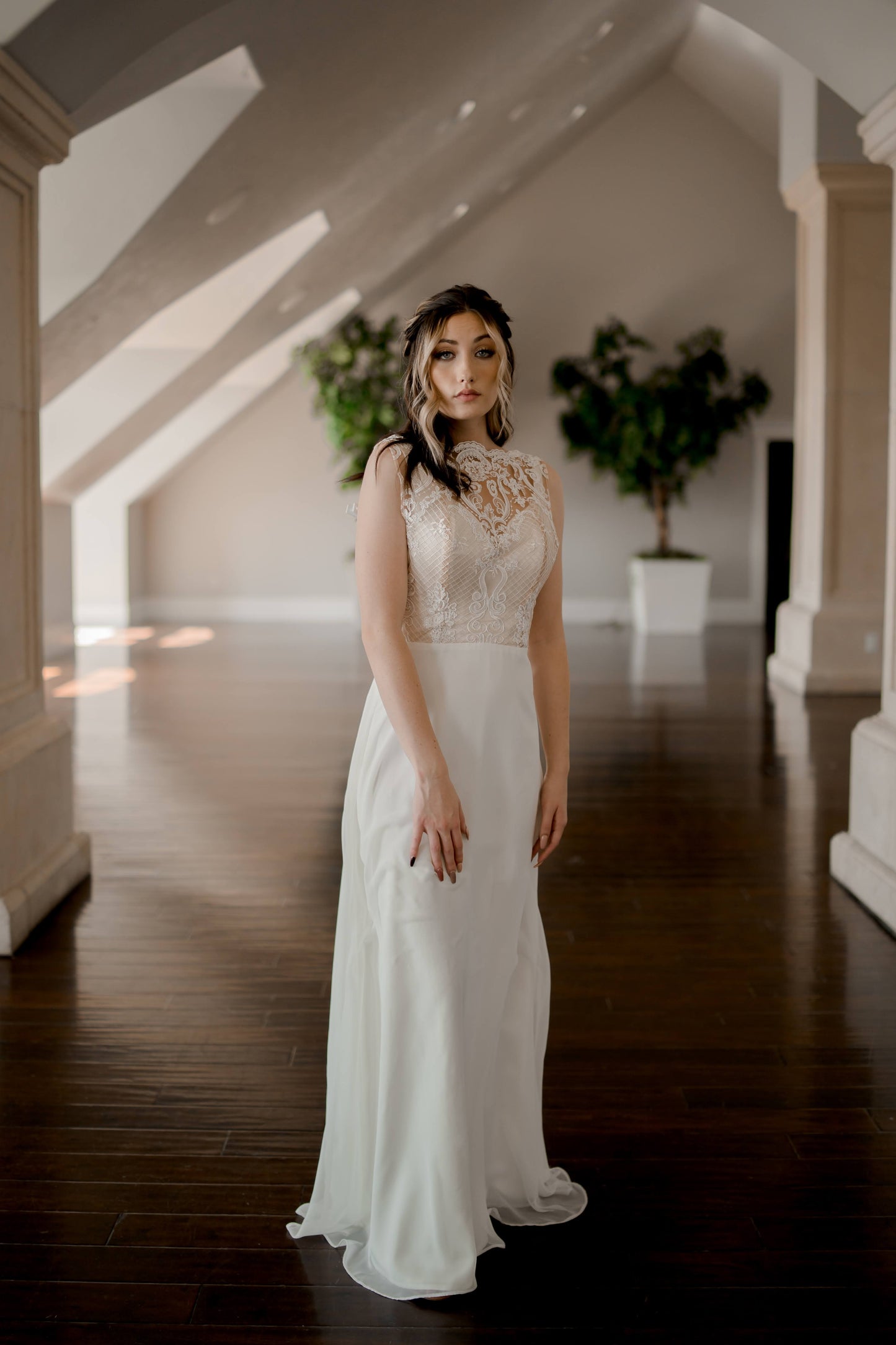 A full length front shot of the winifred wedding gown with the structured satin bodice and wide shoulder straps, chiffon skirt and regal nature.