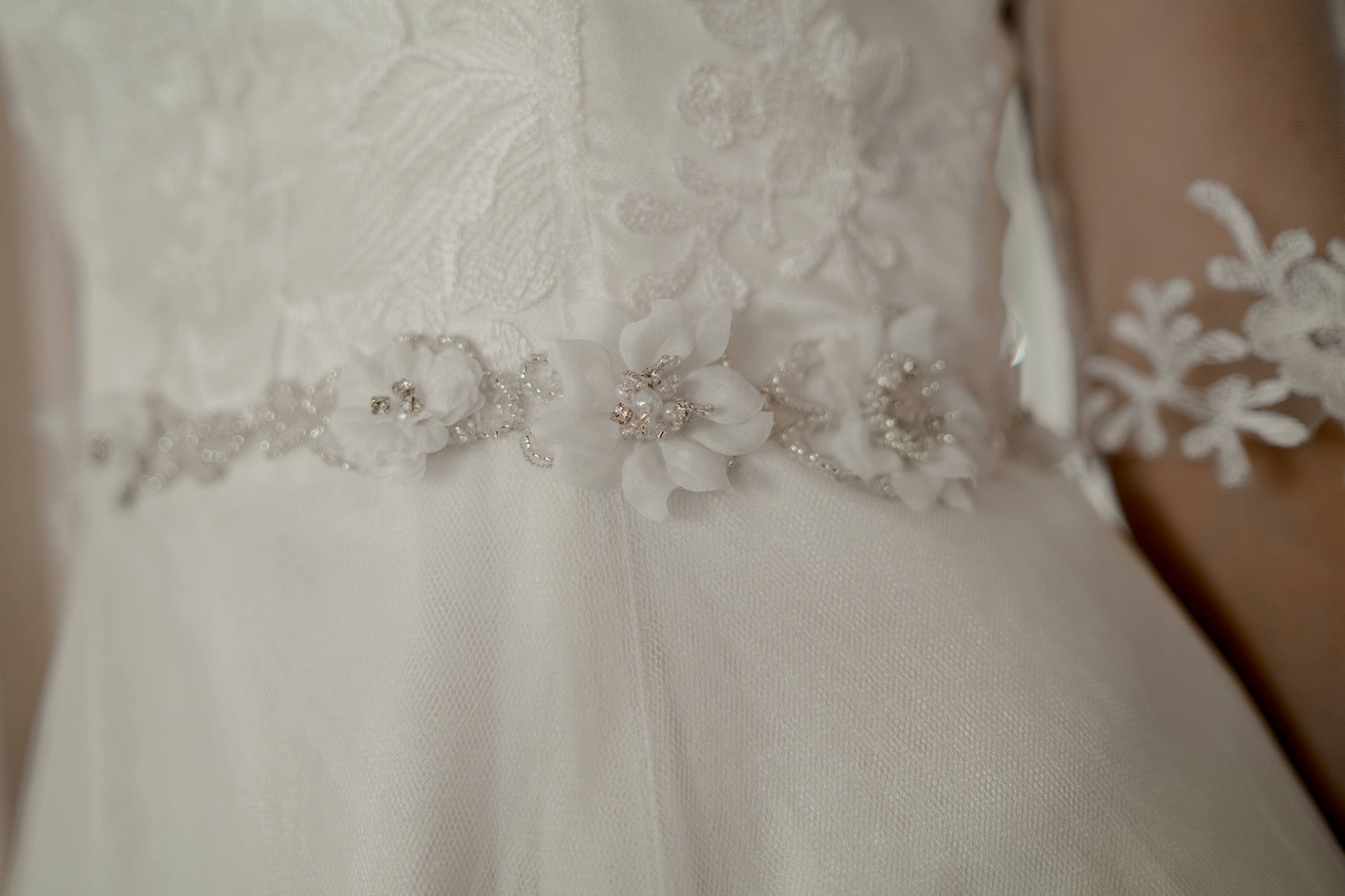 A close up of the 3d floral bridal belt; showing off one of the several styles of flowers with beaded centers.