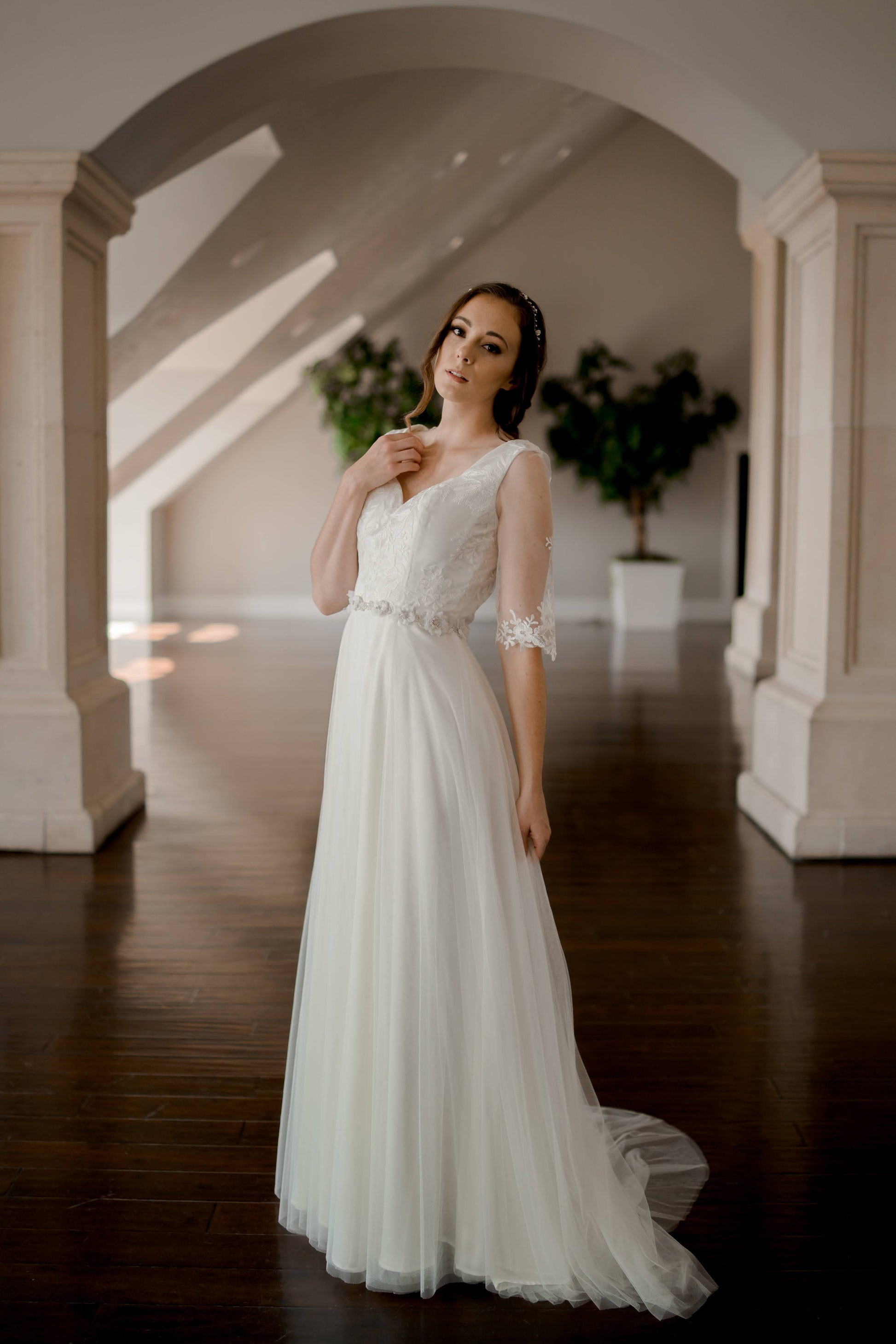 A side view full length photo of one of our gowns paired with the Heidi belt.