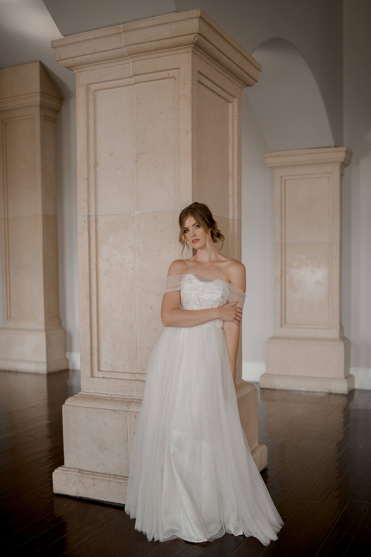 A styled shot of a bride wearing the penelope gown, the gown has a swooped sweetheart neckline, full tulle skirt, and no train.