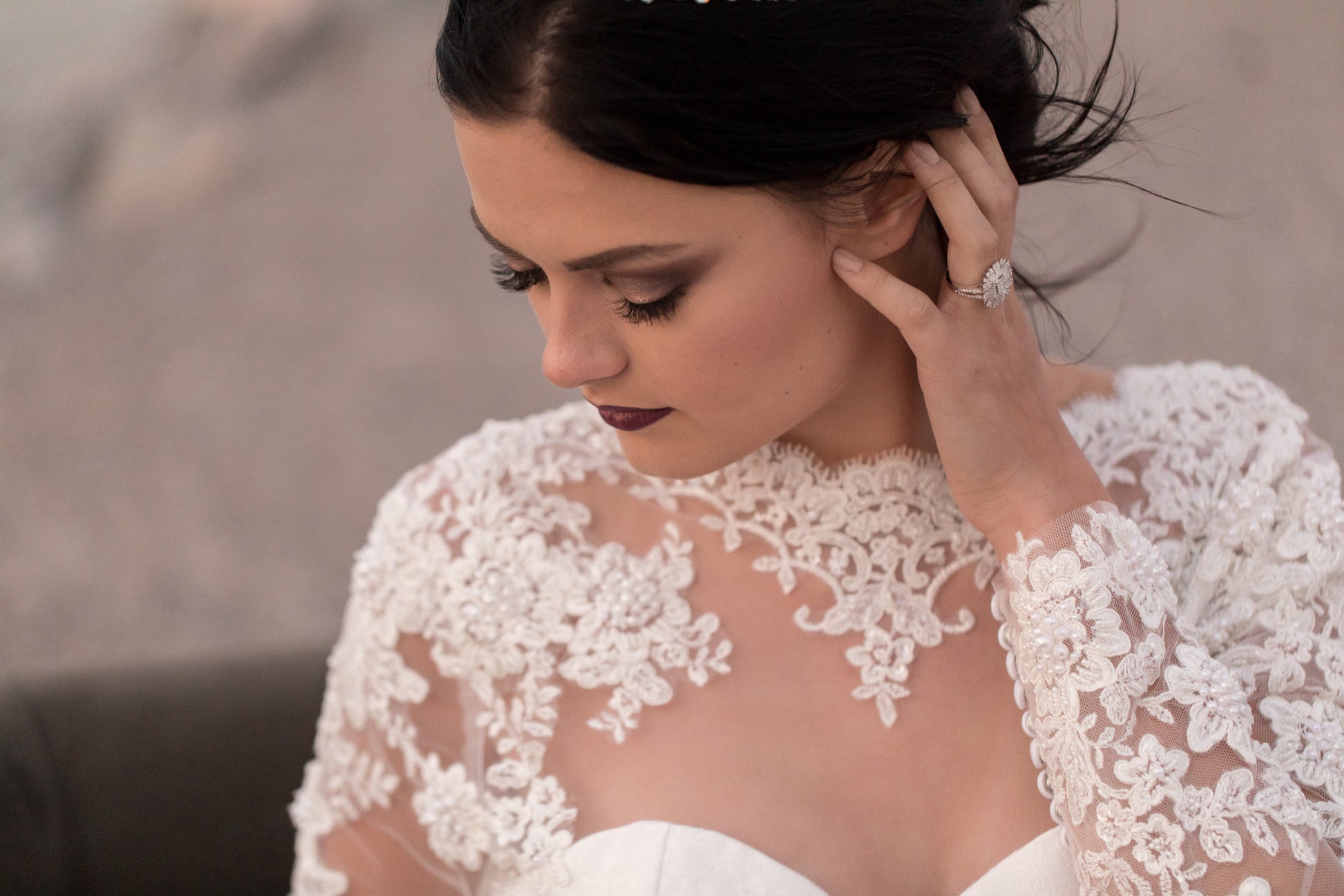 Up close shot of the upper illusion bodice on gemma. A bride wears it as she looks down to the side. Lace detail is whats in focus.