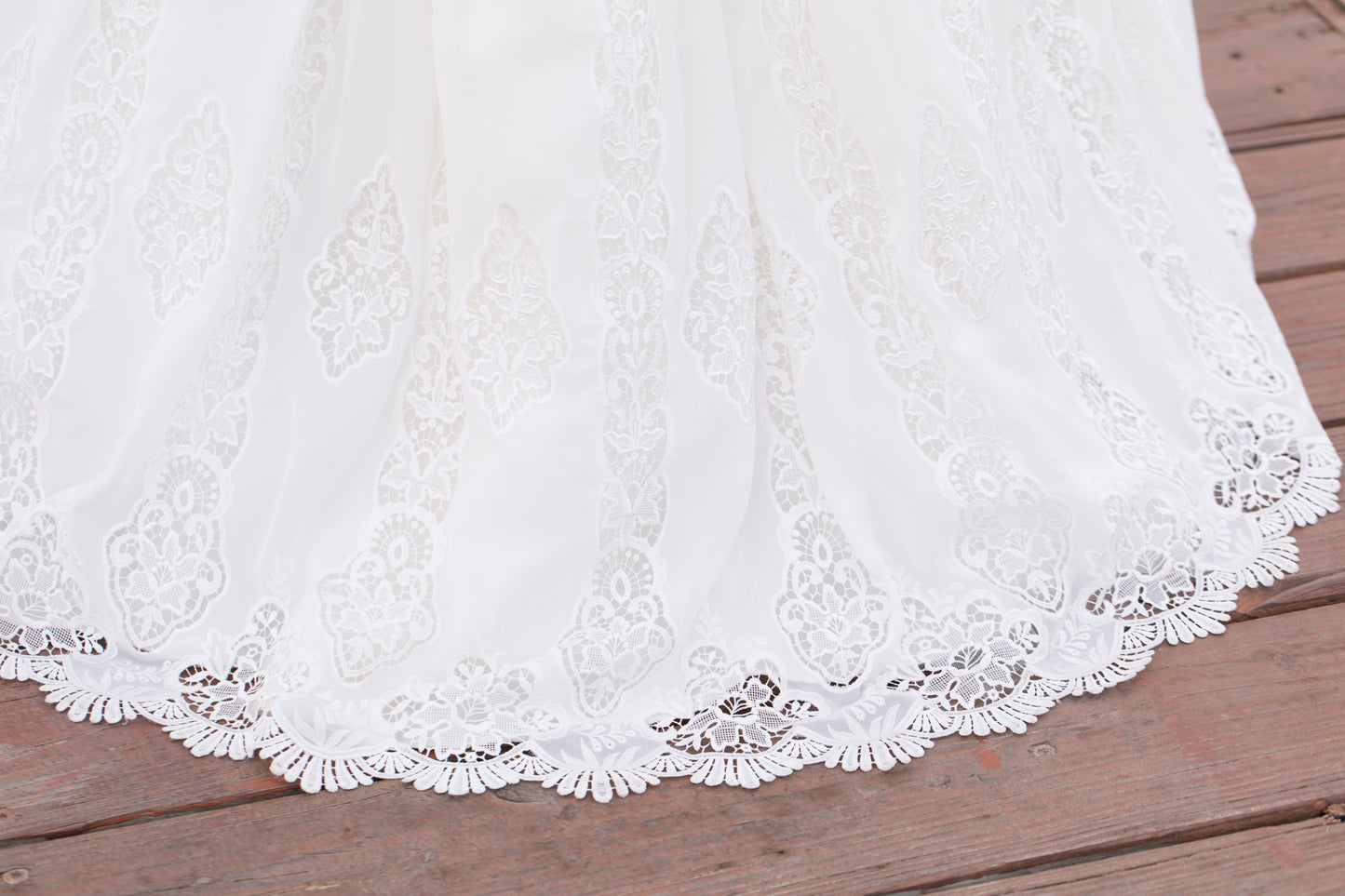 Floral embroidery and scalloped hem on Nerissa’s layered chiffon skirt