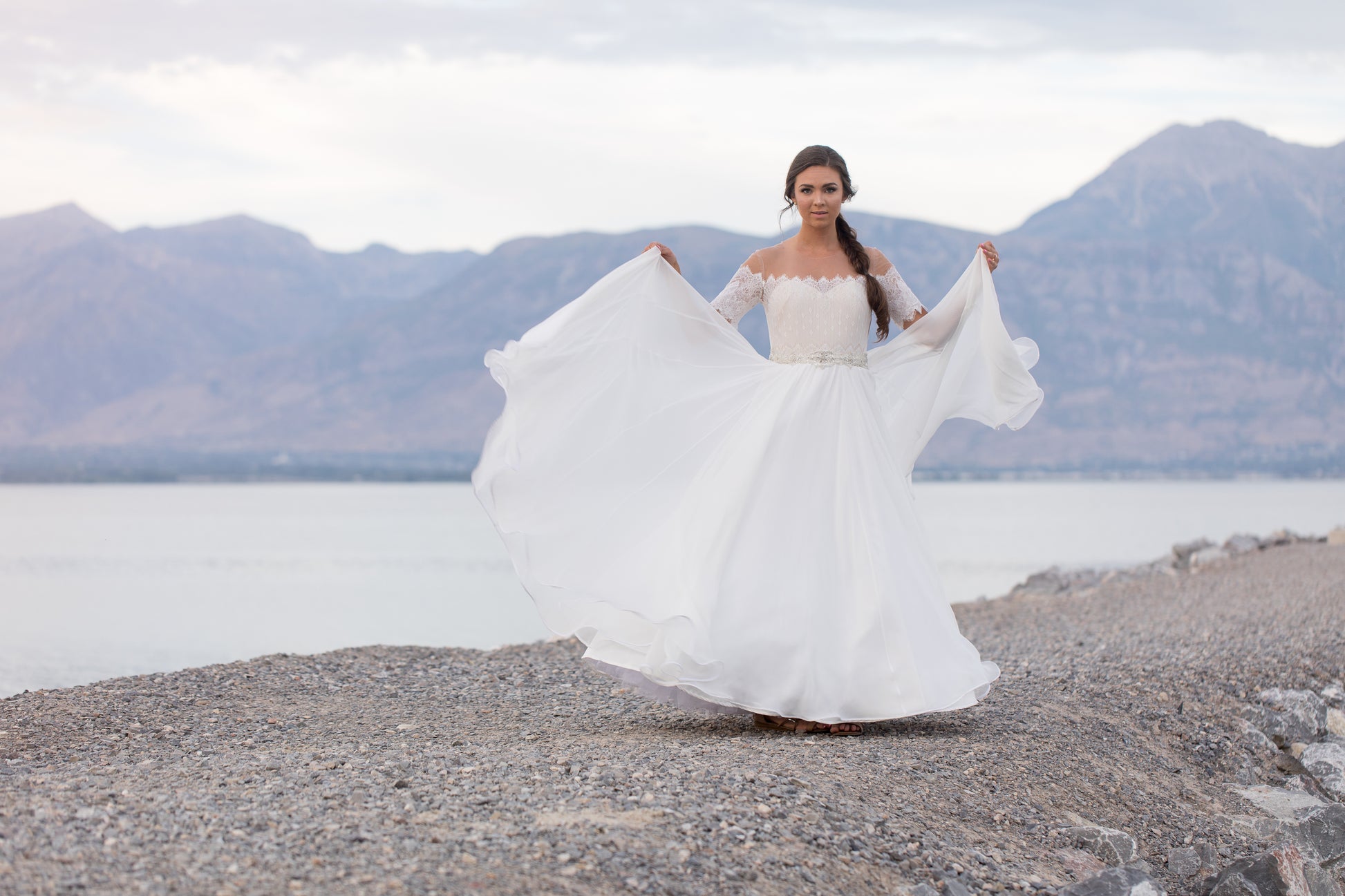 The ronelle gown on a bride; she holds up the skirt as she dances, showing off the ull chiffon skirt with horsehair hem creating soft ripples.