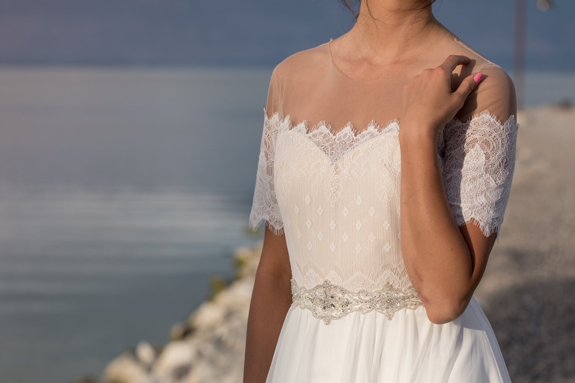Noelle rhinestone belt adding definition and shine at bride’s waistline