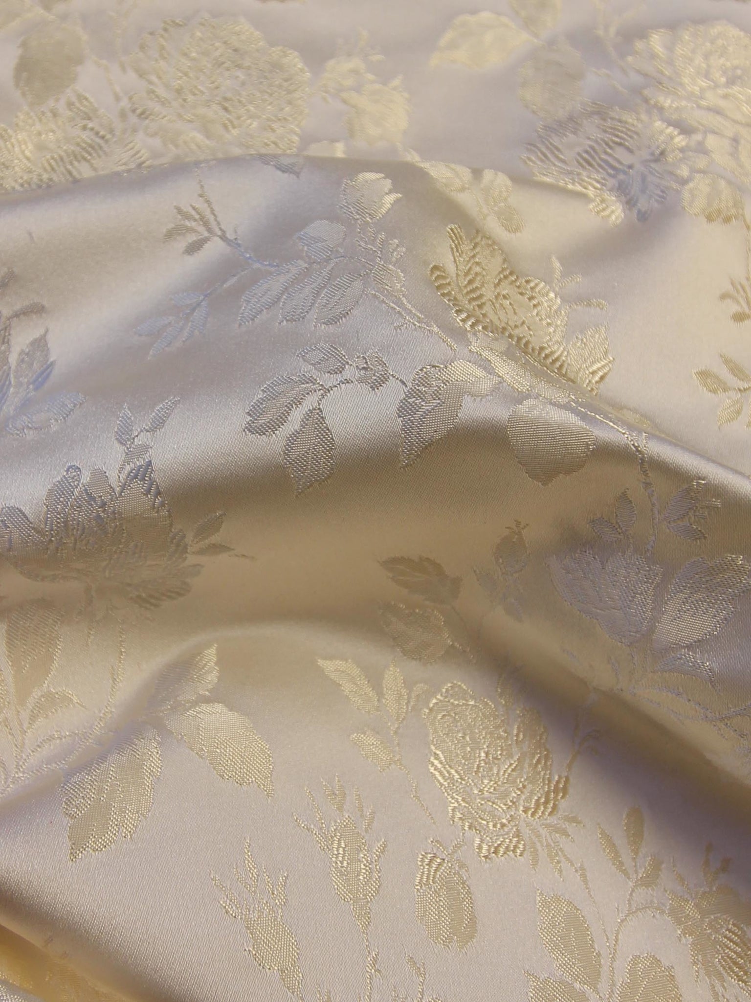 Detailed photo of updated jacquard in Pale Ivory/Champagne with subtle metallic floral pattern.