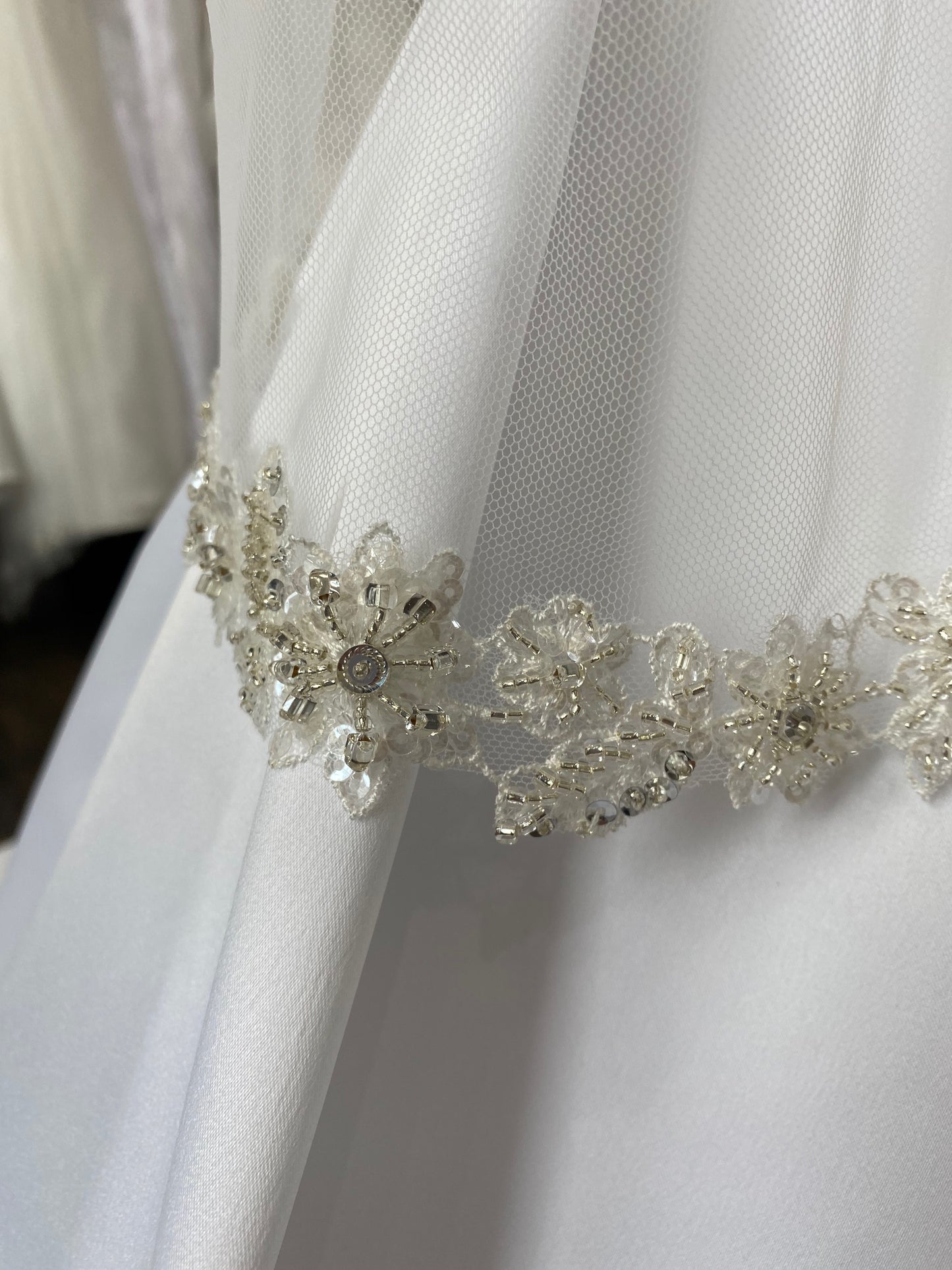 A micro close up of the beaded floral trim on the Haven veil. 