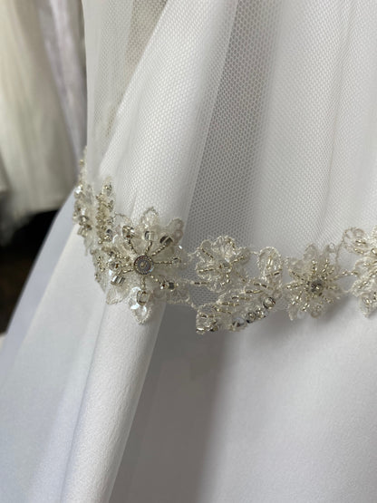 A micro close up of the beaded floral trim on the Haven veil. 