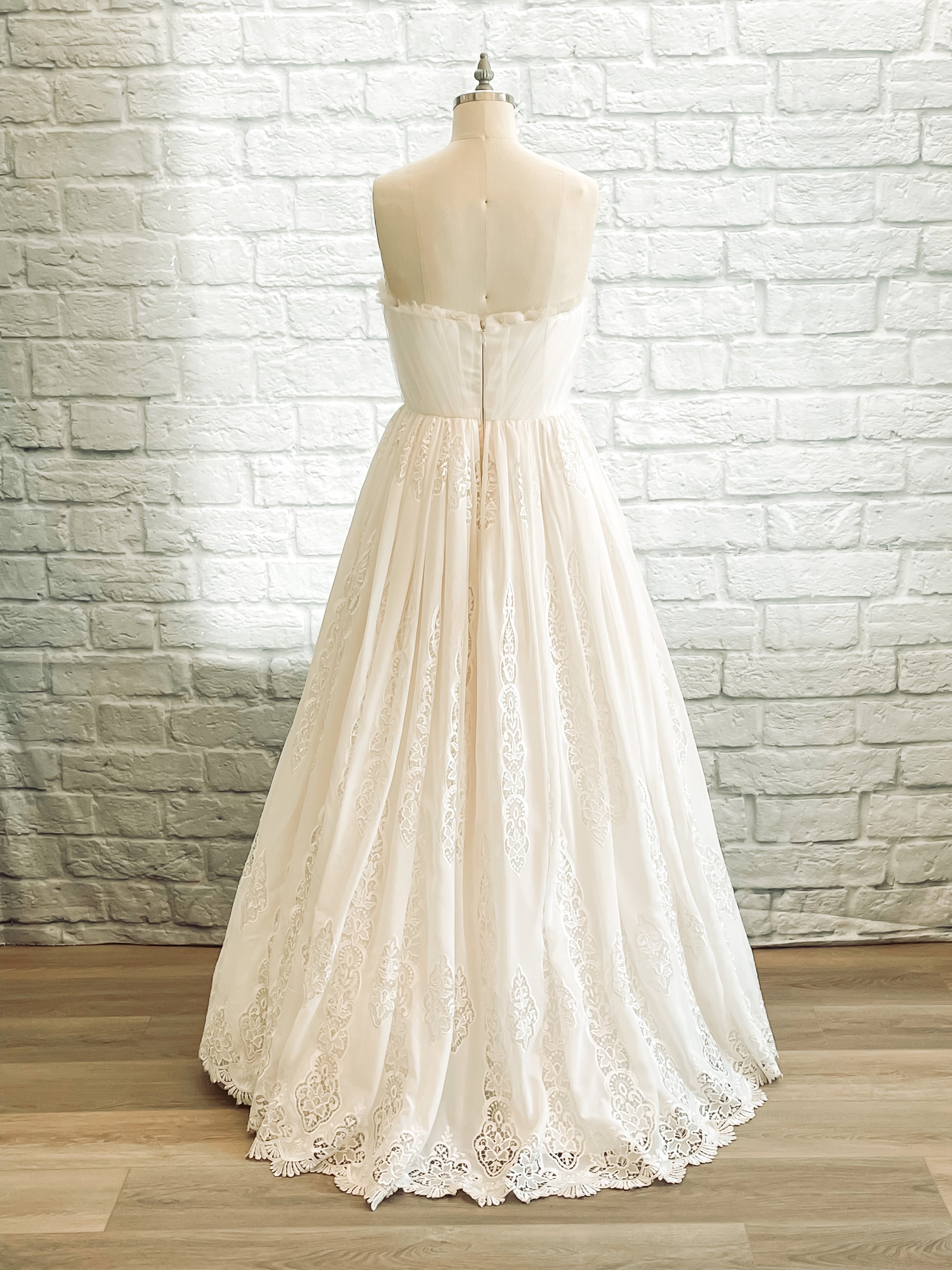 full back image of Princess-style wedding dress with layered tulle and floral embroidery details