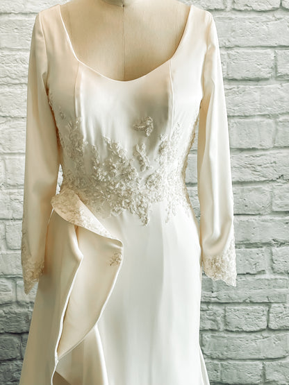 Closer shot of the front bodice and upper skirt of Emma. Showing off the lace placement, ruffle cascade, and long sleeves.