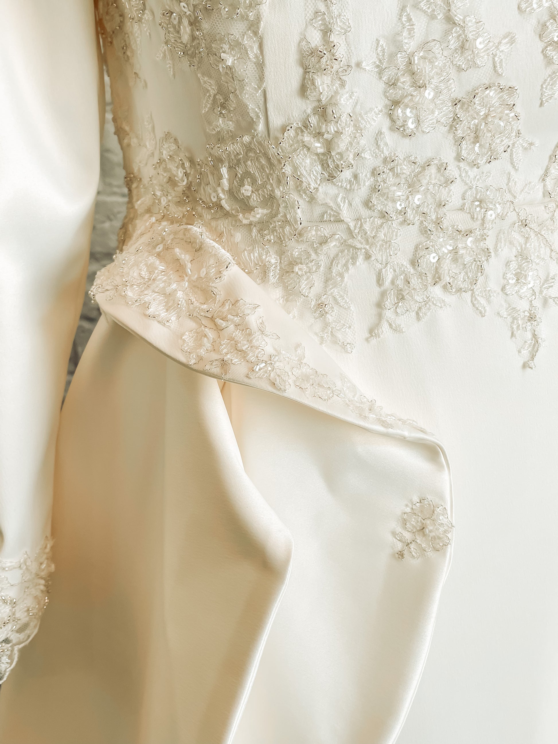 Detail shot of Emma’s waist seam  and ruffle that are adorned with lace trickling pieces.