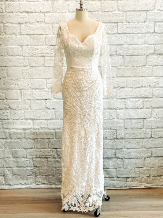 Front view of Octavia bridal gown with beaded lace skirt and sheer lace sleeves