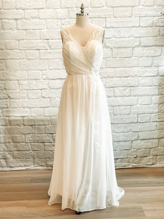 Front view of Odette wedding gown with draped chiffon bodice and faux wrap skirt