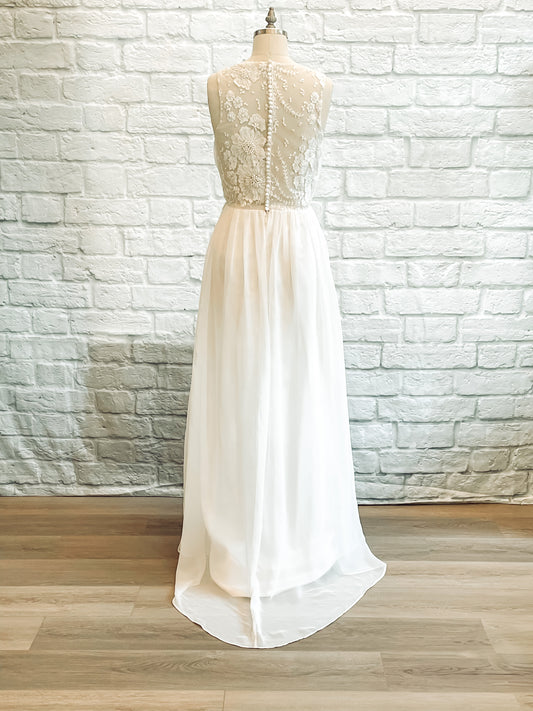 Back view of Odette bridal dress featuring sheer lace back and button detailing