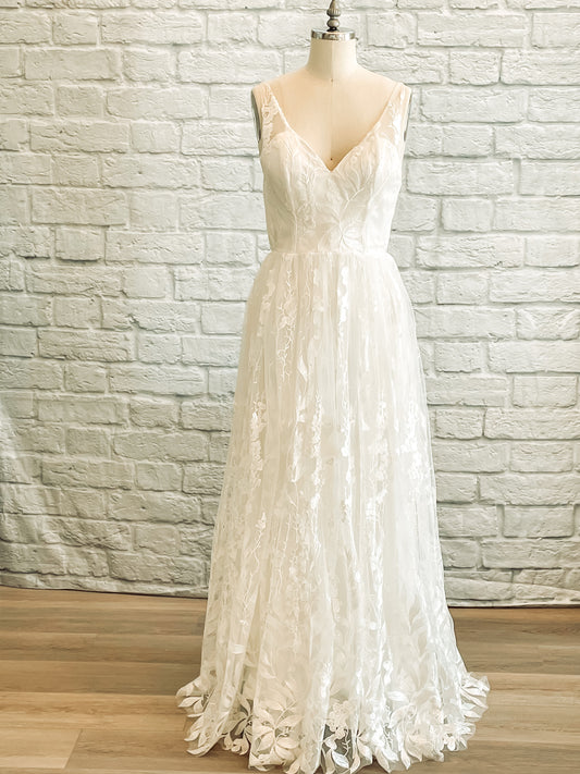 Full front of the Rosie wedding dress on a mannequin with a sequin lace overlay and tank-style straps.