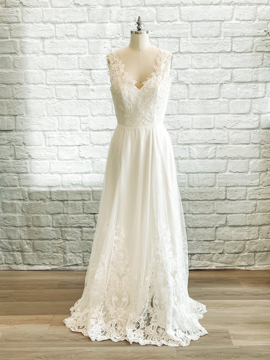 Marie satin and lace wedding gown with sweetheart neckline and illusion tank straps shown from the front on a mannequin.