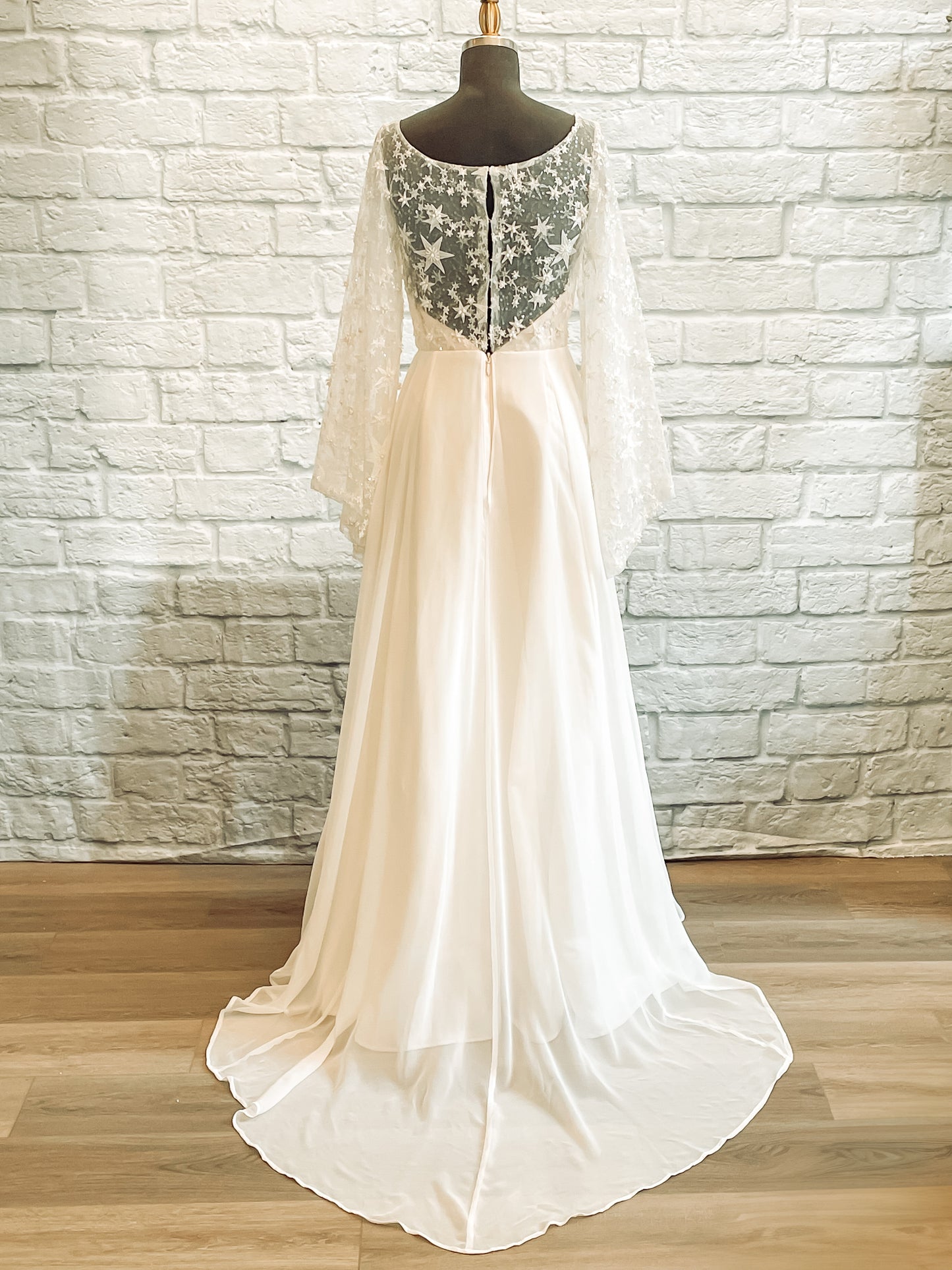 Back view of Novelli wedding dress with bell sleeves and constellation-inspired lace details