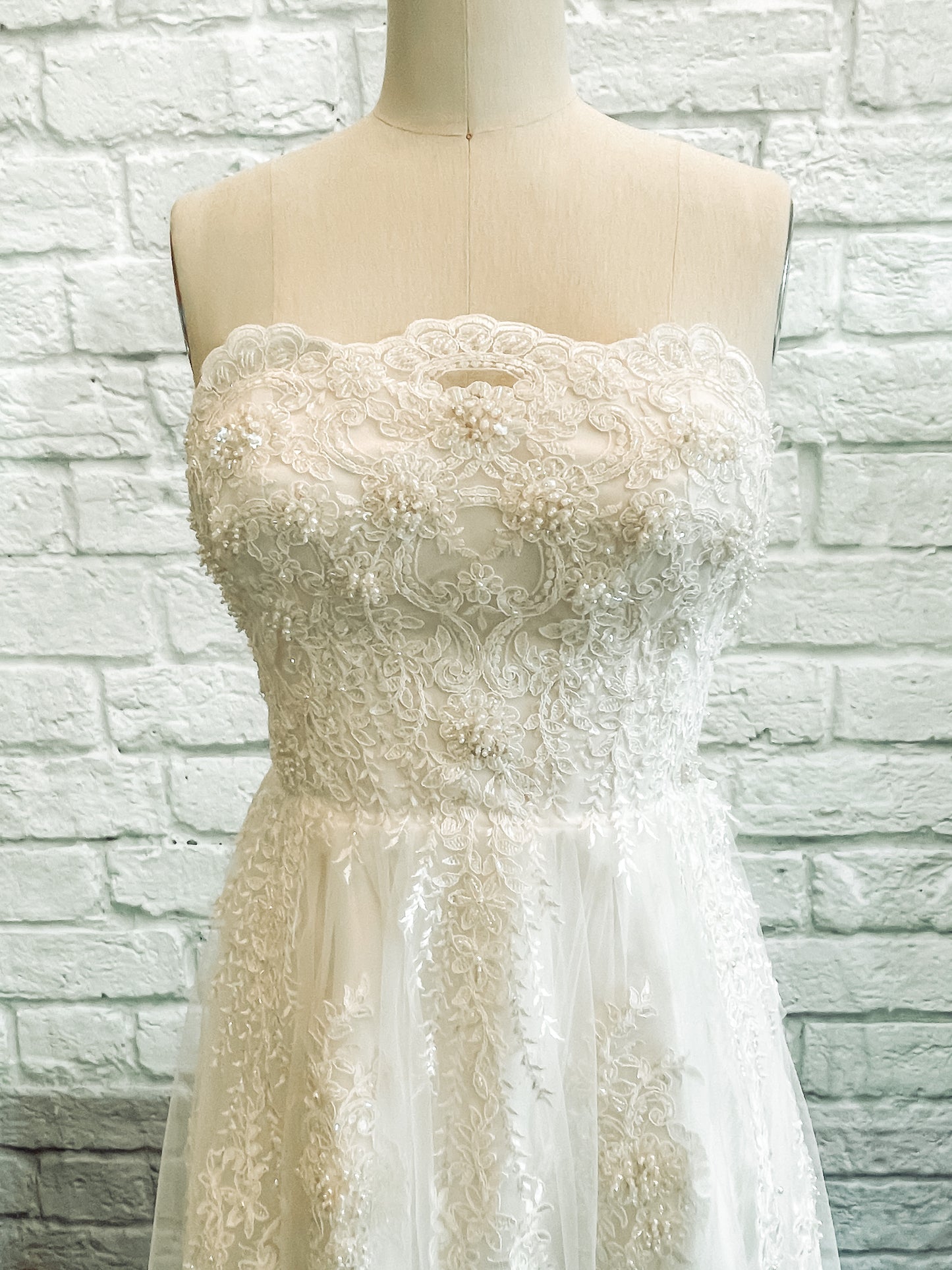 Front bodice view , the focus is on the Scalloped straight-across lace neckline with pearl and sequin floral details