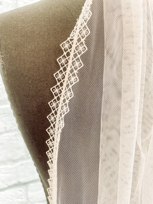 Close-up of diamond and floral lace trim on the Serenity wedding veil.