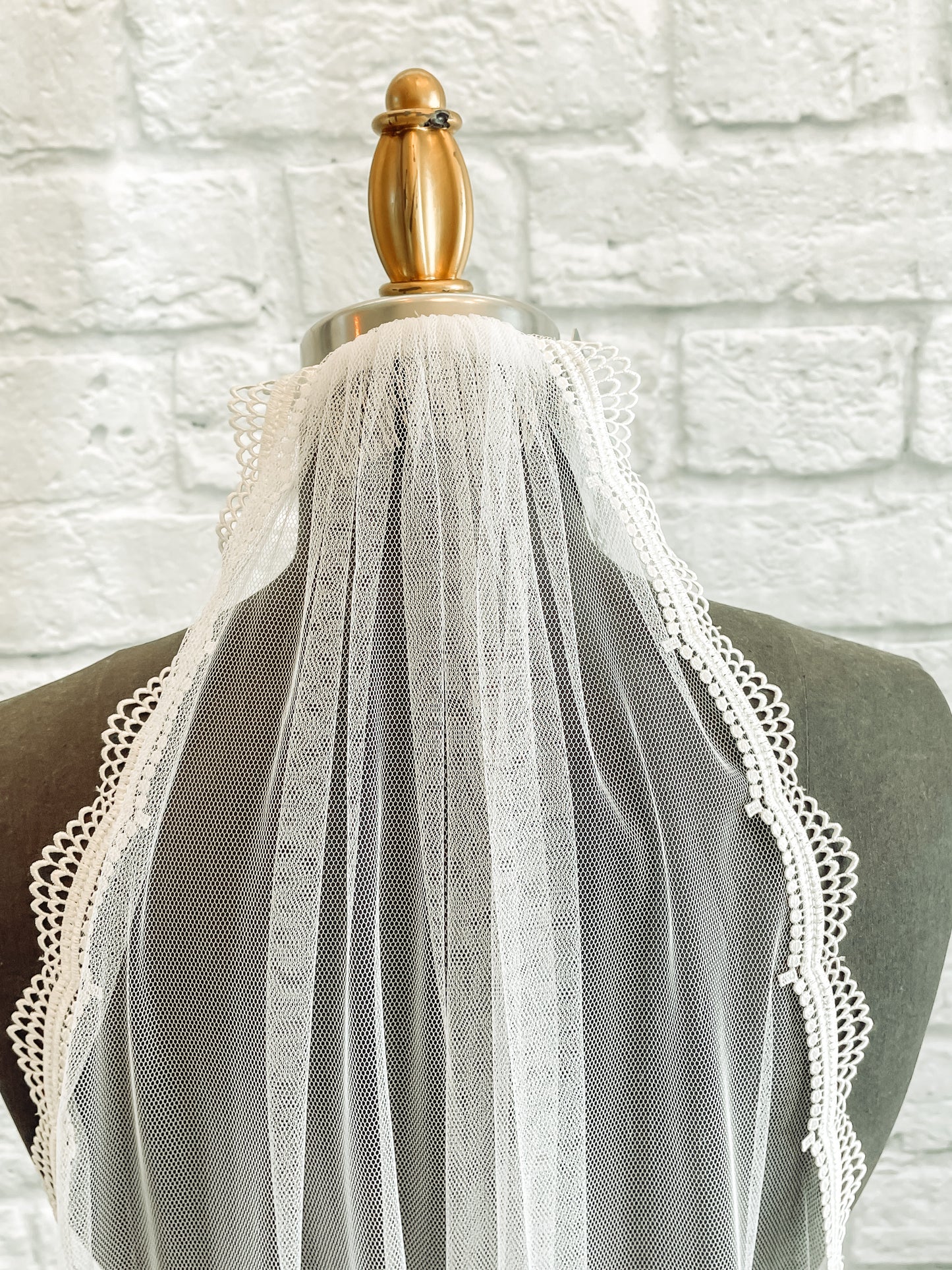 A close up of the comb attachment and scalloped edges on the Brennan bridal veil. 