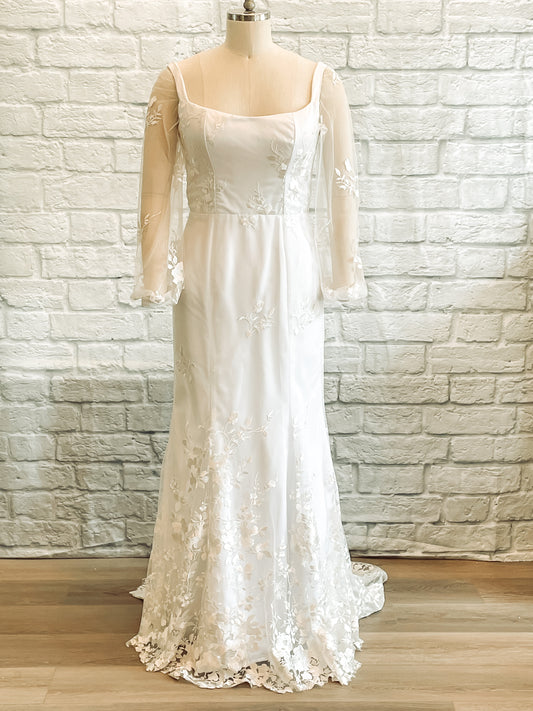 Violet gown on a mannequin showcasing the full front view, square neckline and fit and flare silhouette