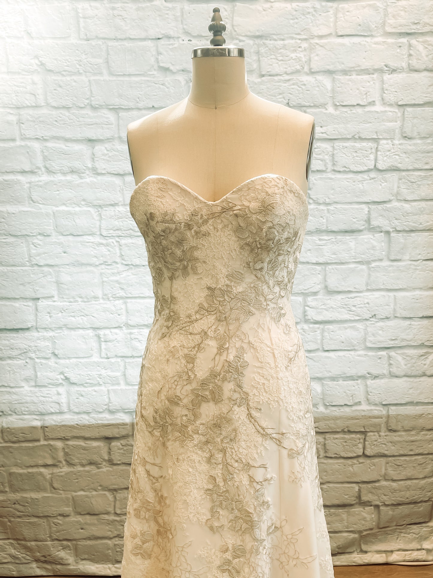 Hand-placed lace on bodice with visible transition between lace types.