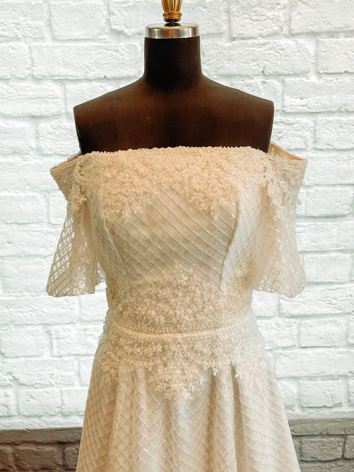 Parker gown front bodice with diamond tulle, straight-across neckline, beaded trim, and puff sleeves.