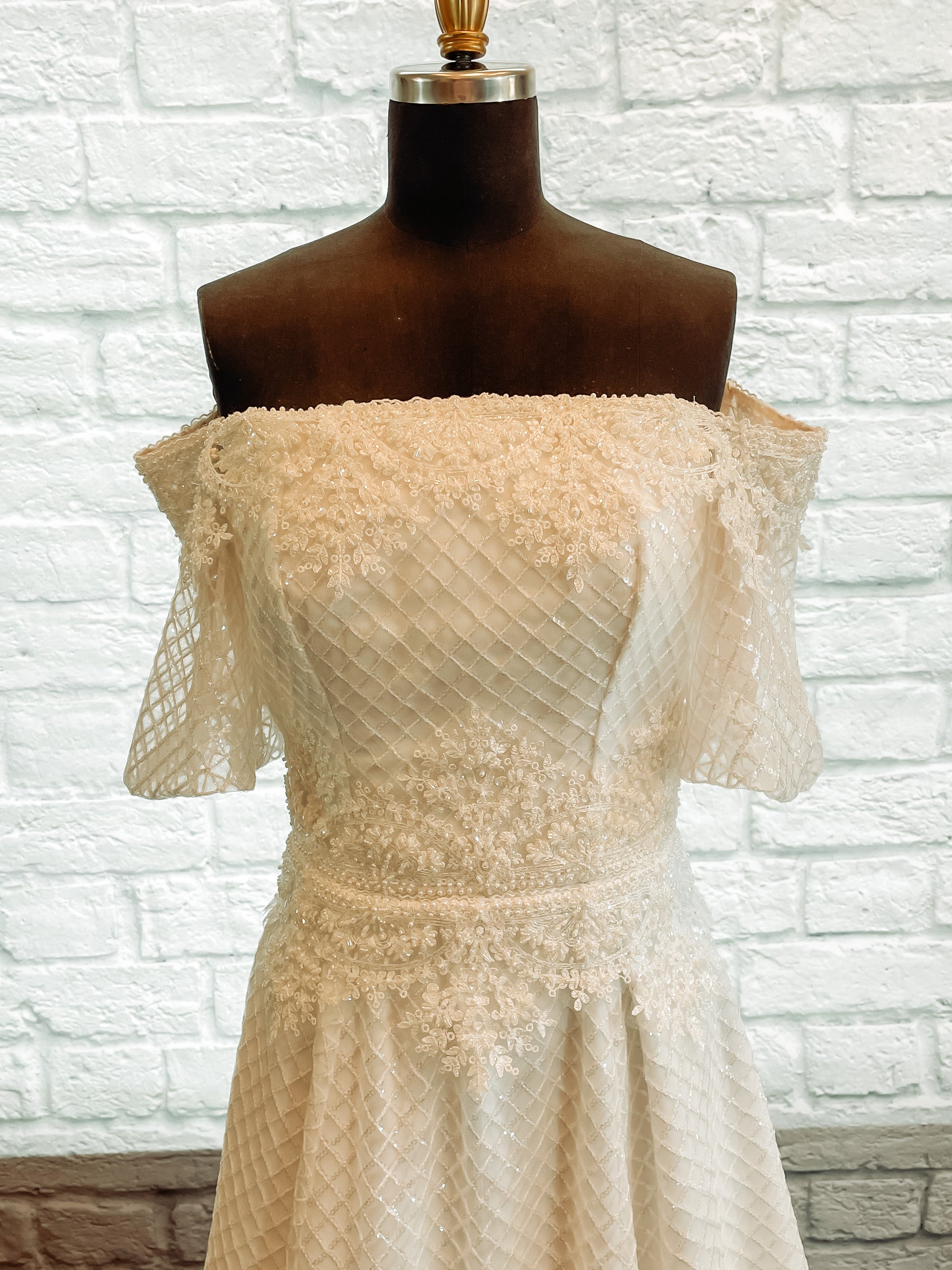 Parker gown front bodice with diamond tulle, straight-across neckline, beaded trim, and puff sleeves.