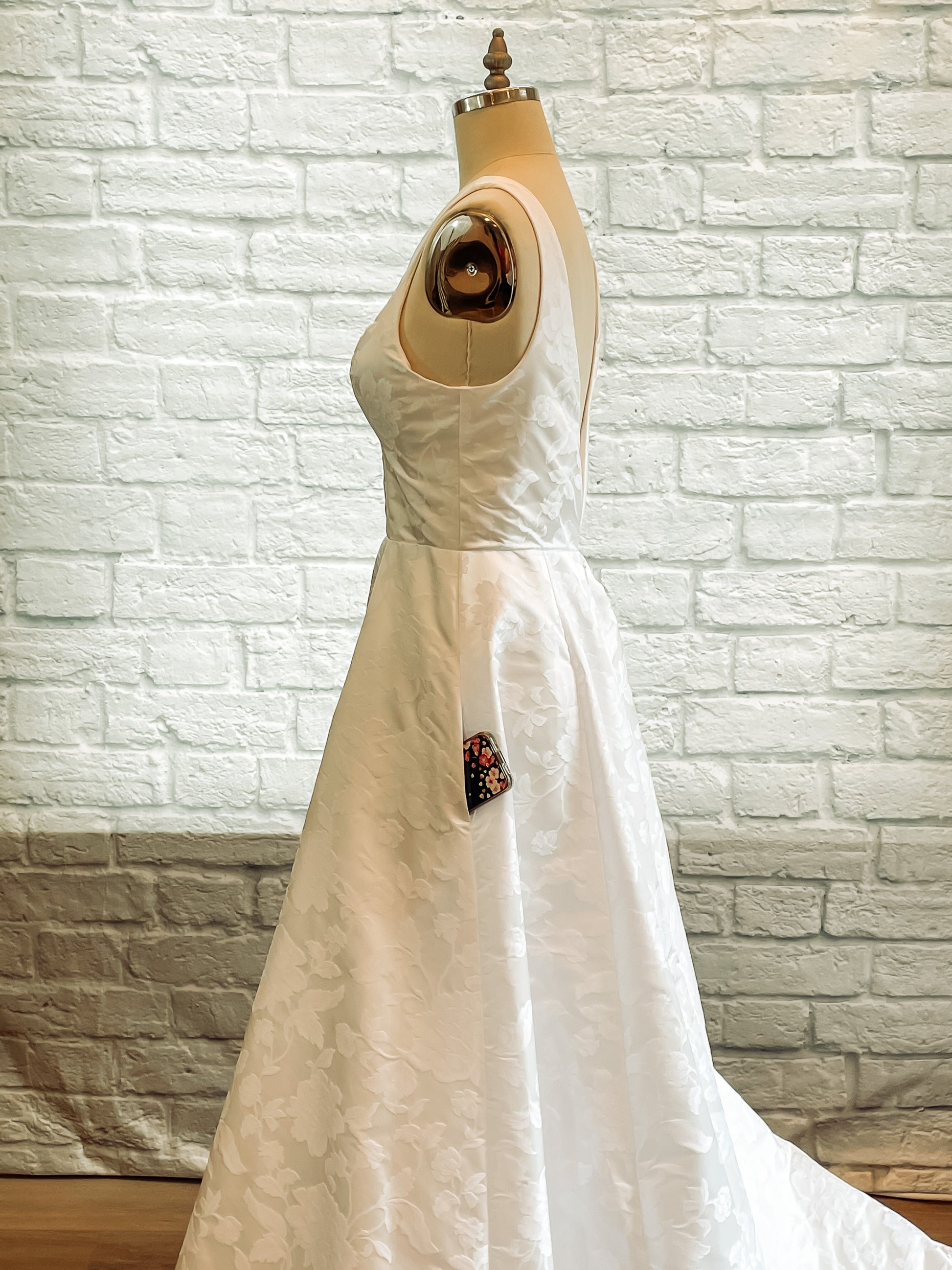 Side profile of the Madison gown, Showing a phone in the side pocket and how discreet it is. 