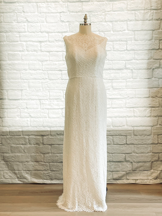 Front view of the Blair gown displayed on a mannequin, showcasing its all-lace overlay, boat neckline, and figure-hugging column silhouette.