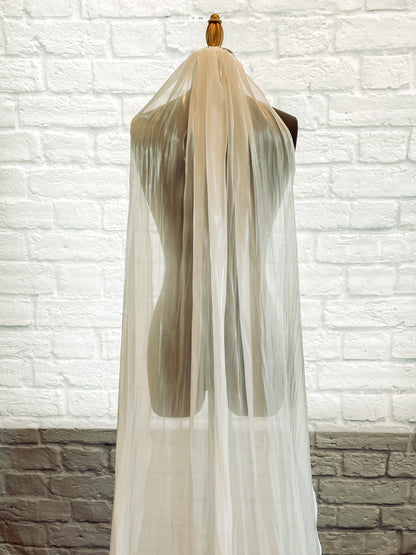 A close up photo of the cara veil; a Pale ivory light-reflecting veil for modern bride shows ff the sheen in this photo. 