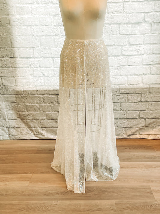 A full front image of the calliope bridal skirt shown in the ivory glitter tulle with a seperating full front slit. 