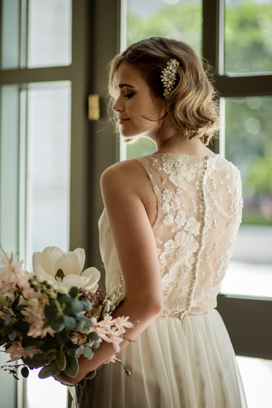 Close-up of stitched floral lace back on Odette gown