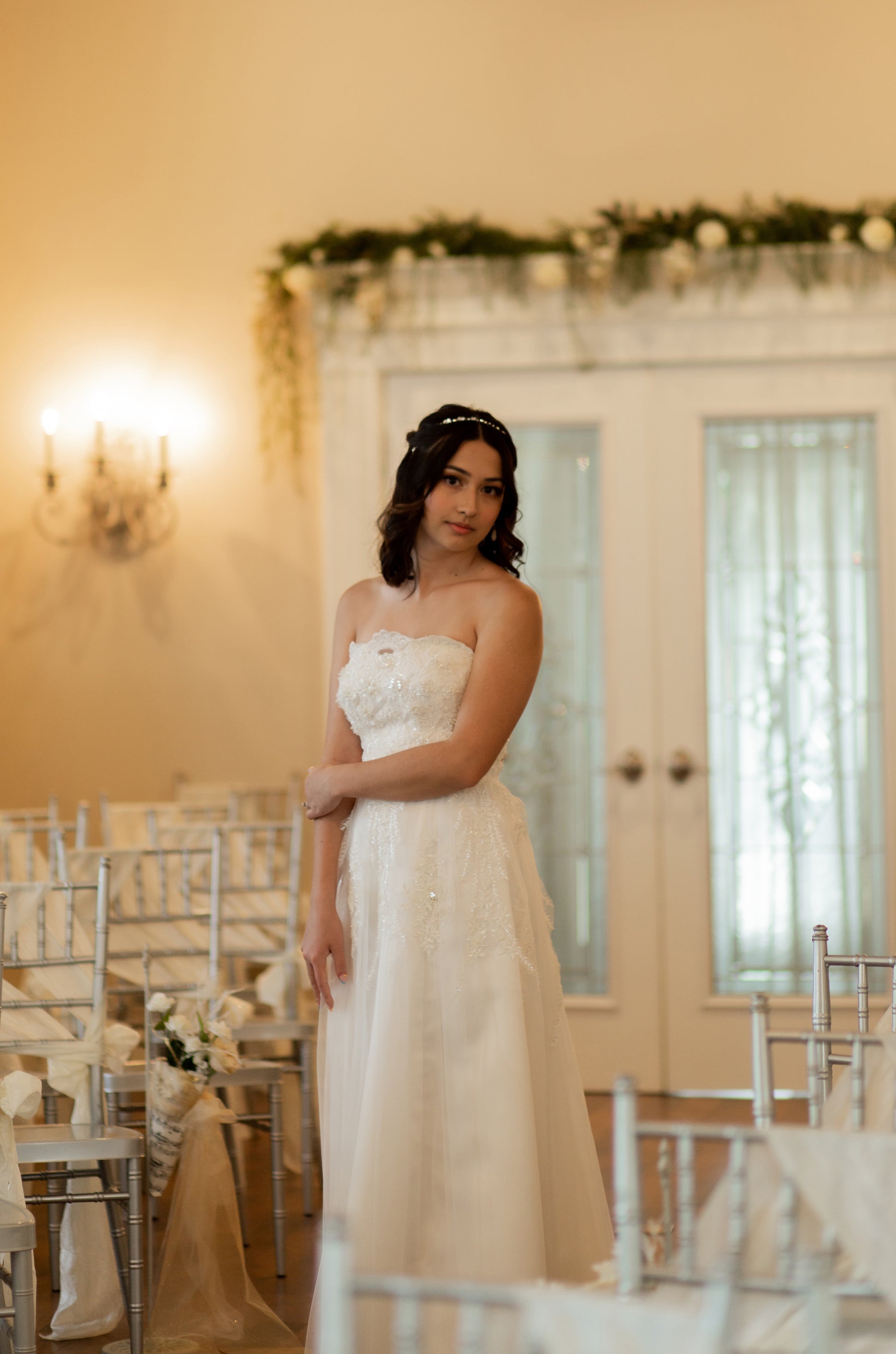 Angled front view of the kennington dress on a model. Shows the Slim A-line silhouette showing bodice structure and gathered tulle.