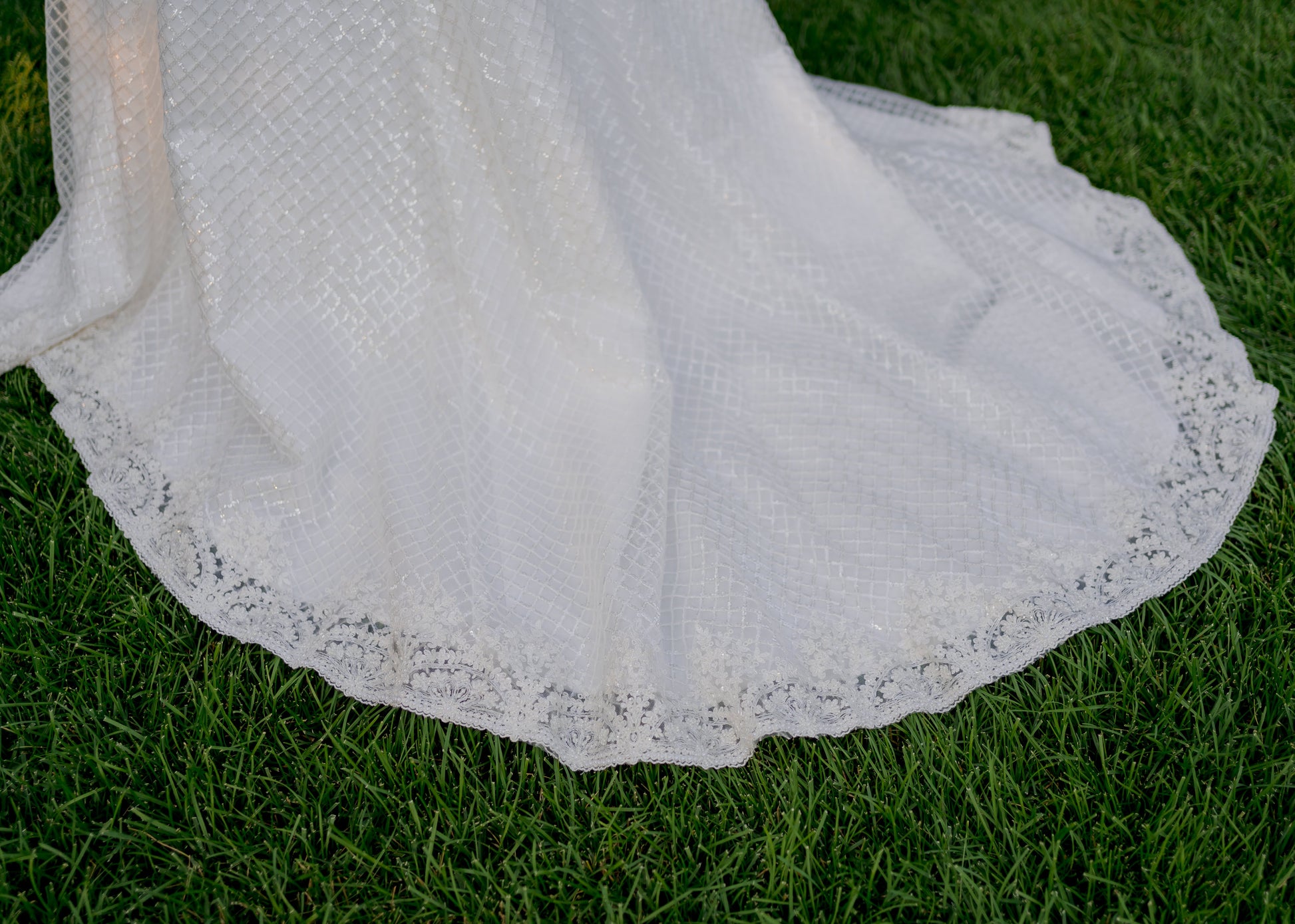 Mini scalloped beaded trim detail of the hem and train of the Parker bridal gown. 