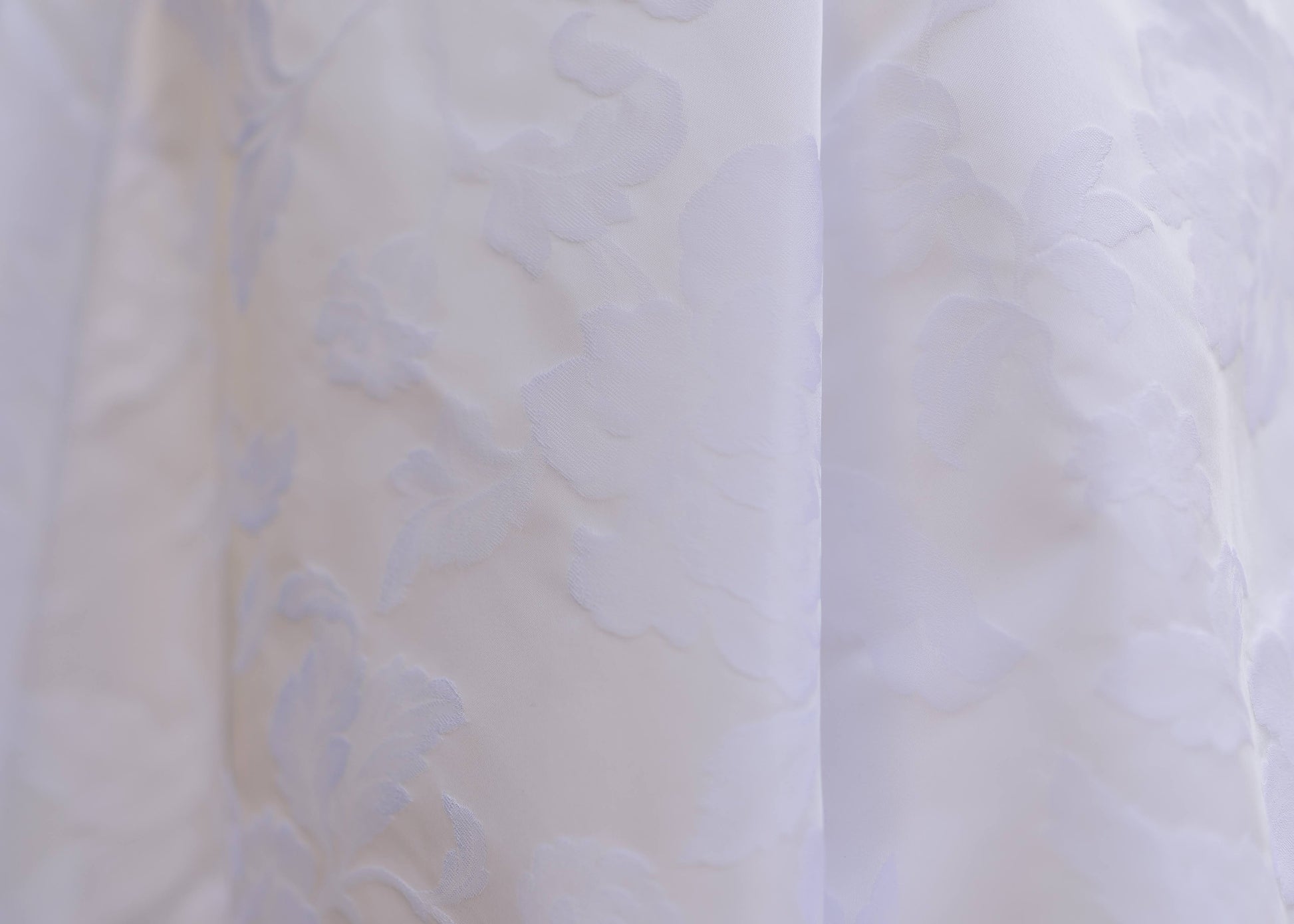 Very upclose shot of the Textured floral jacquard wedding fabric on the madison gown. 
