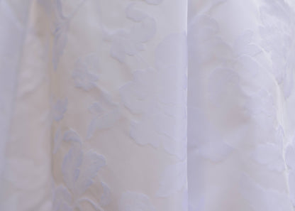 Very upclose shot of the Textured floral jacquard wedding fabric on the madison gown. 