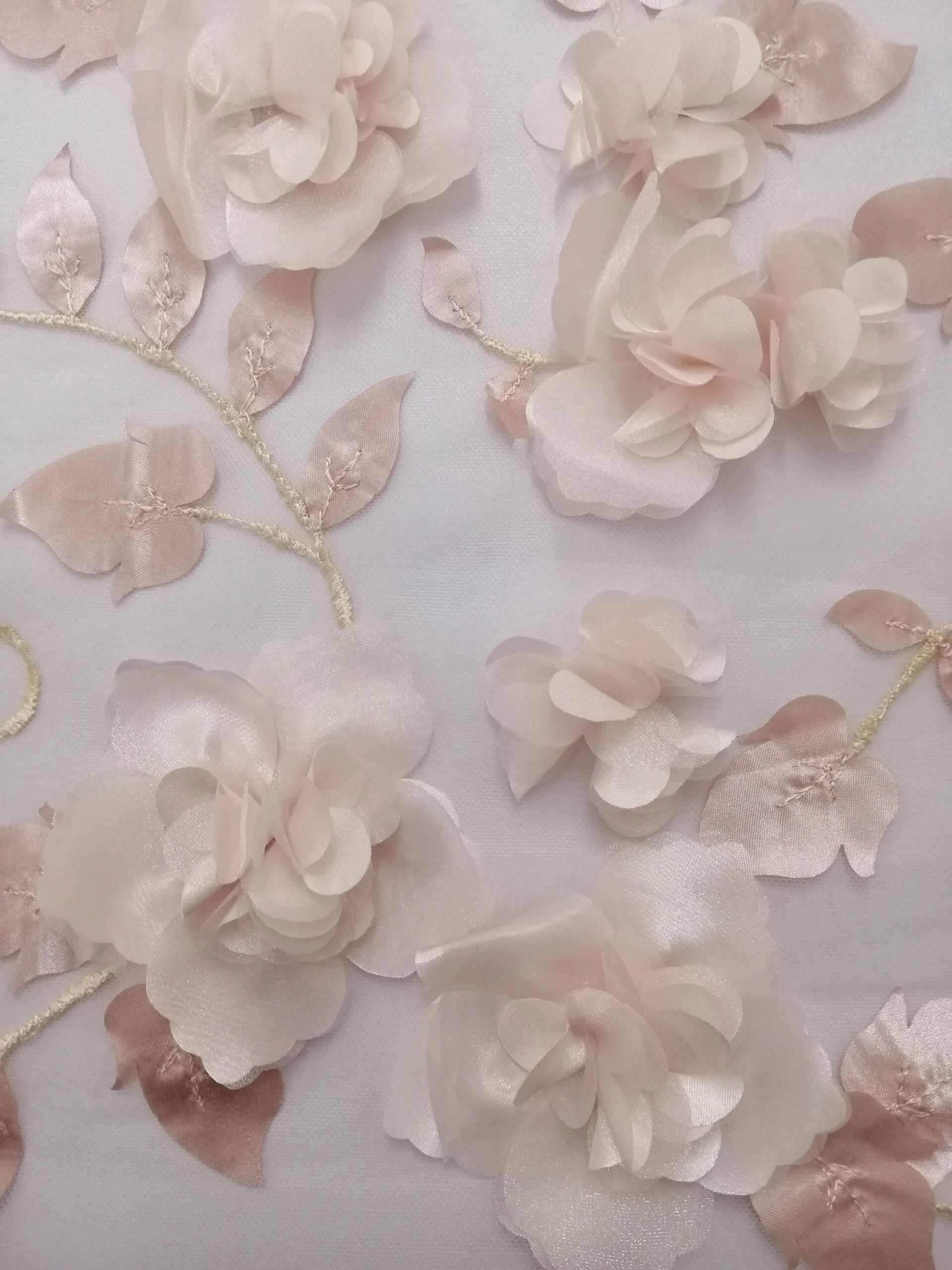 A Close-up of floral appliqué on romantic bridal veil, Celine, in the blush color option. 