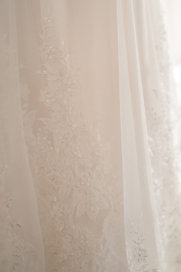 A line with slit, key hole back, sweetheart bridal neckline, beaded lace bodice, ivory beaded lace skirt,