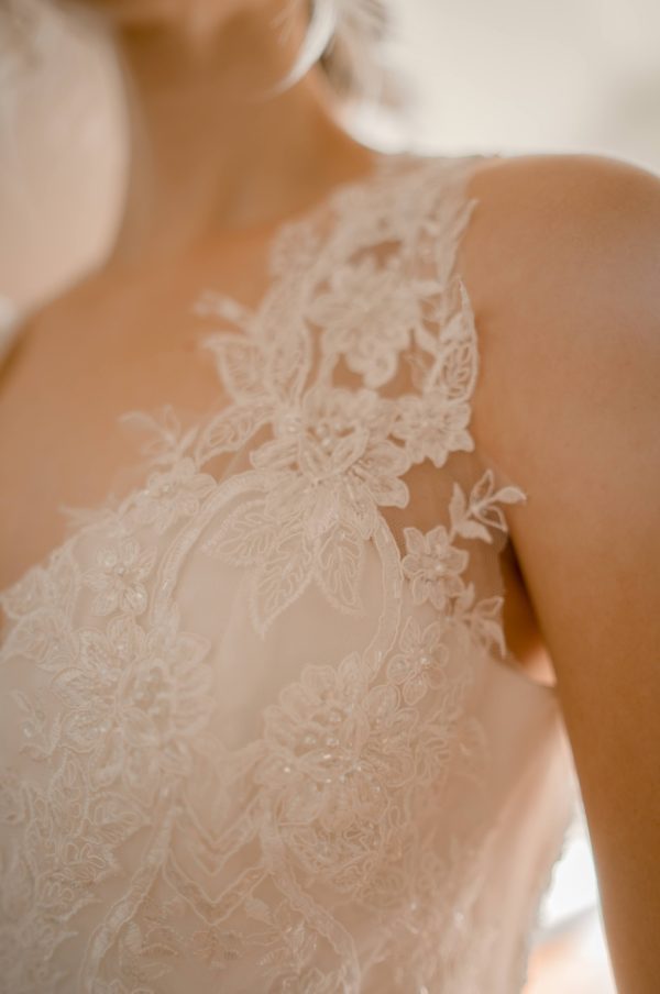 A line with slit, key hole back, sweetheart bridal neckline, beaded lace bodice, ivory beaded lace skirt,